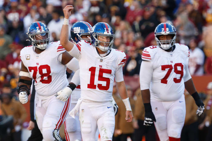 New York Giants quarterback Tommy DeVito celebrates after throwing a touchdown pass against the Washington Commanders during the second quarter at FedExField.